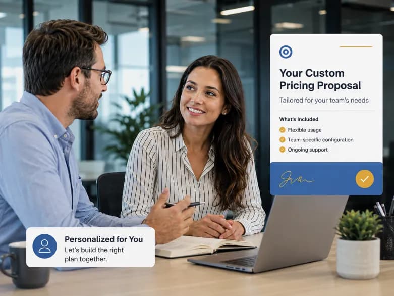 Two teammates discussing a personalized pricing proposal at a laptop